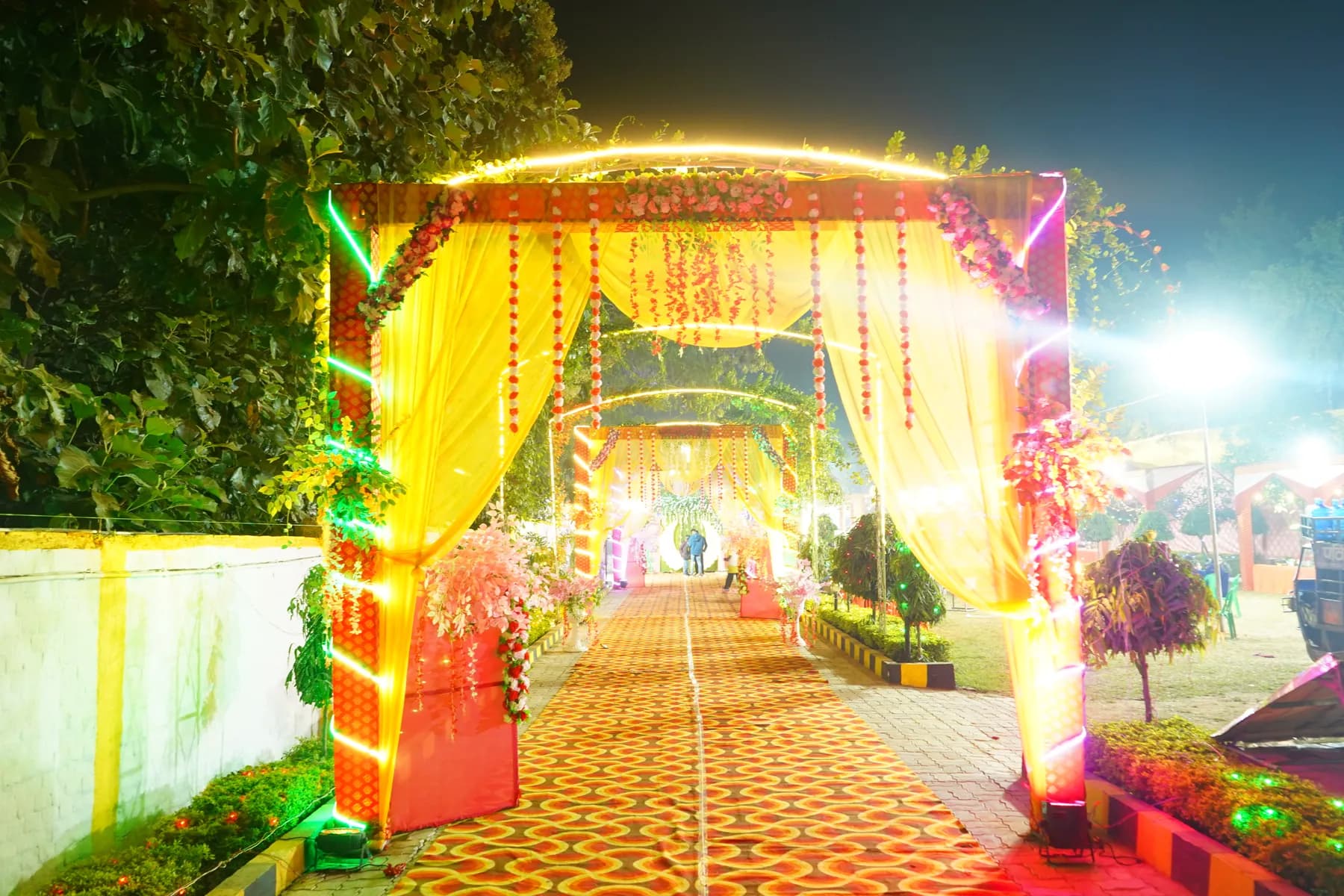 Decorated entrance gate and lit walkway